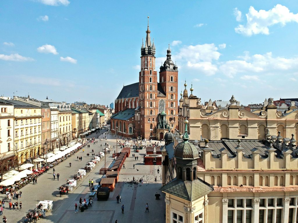 St. Mary’s Basilica overlooking Krakow’s Main Square on a sunny summer day with tourists