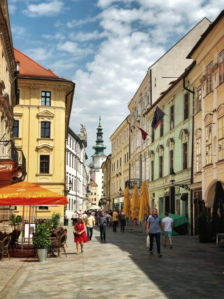 Pedestrian street in Bratislava Old Town with cafés and tourists