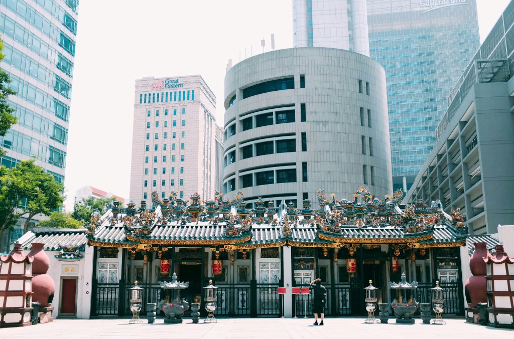 Yueh Hai Ching Temple in Singapore’s CBD with ornate roof against modern skyscrapers.