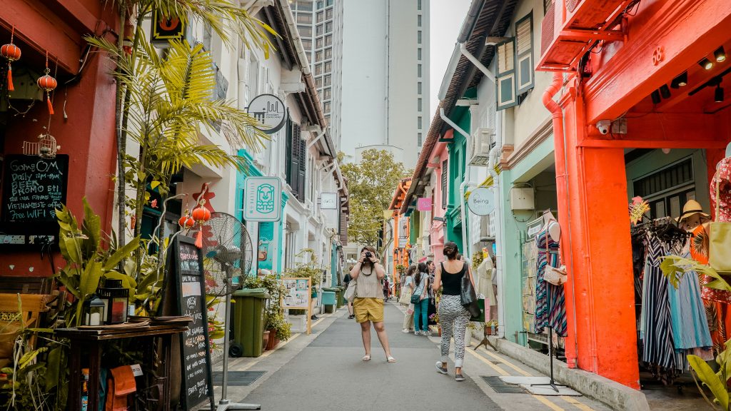Colorful heritage shophouse street in Singapore near Chinatown, close to famous temples.